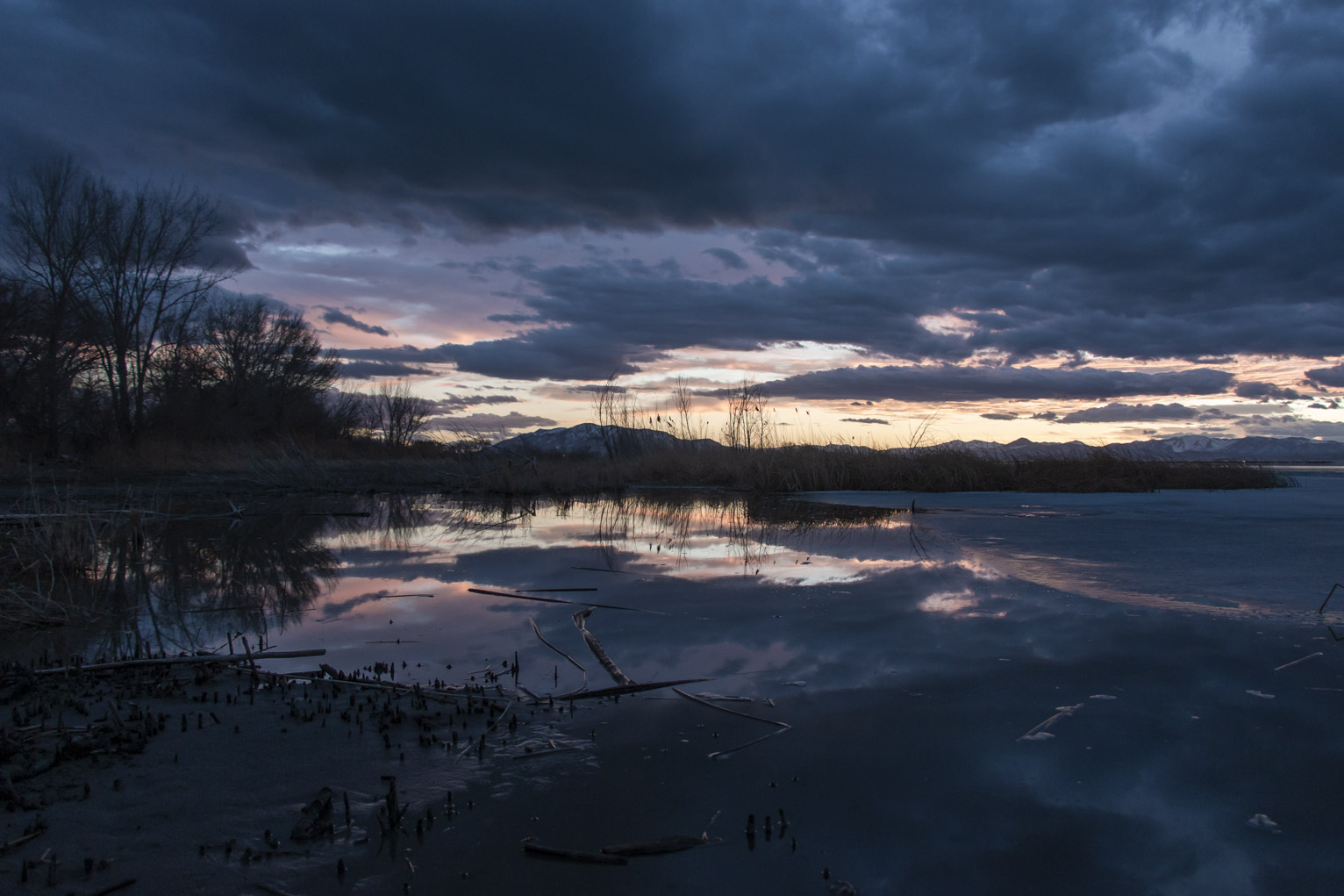 Awhile after sunset the sky turns purple and is reflected in the calm water of the lake